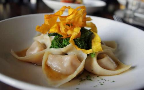 Slow roasted butternut squash tortelloni with sage brown butter sauce and sautéed rapini