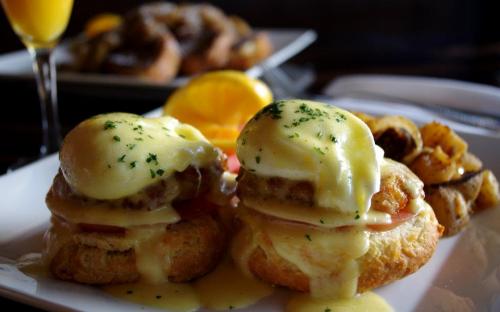 House-made biscuits topped with poached eggs, mini crab cakes, sliced tomato, and Hollandaise sauce